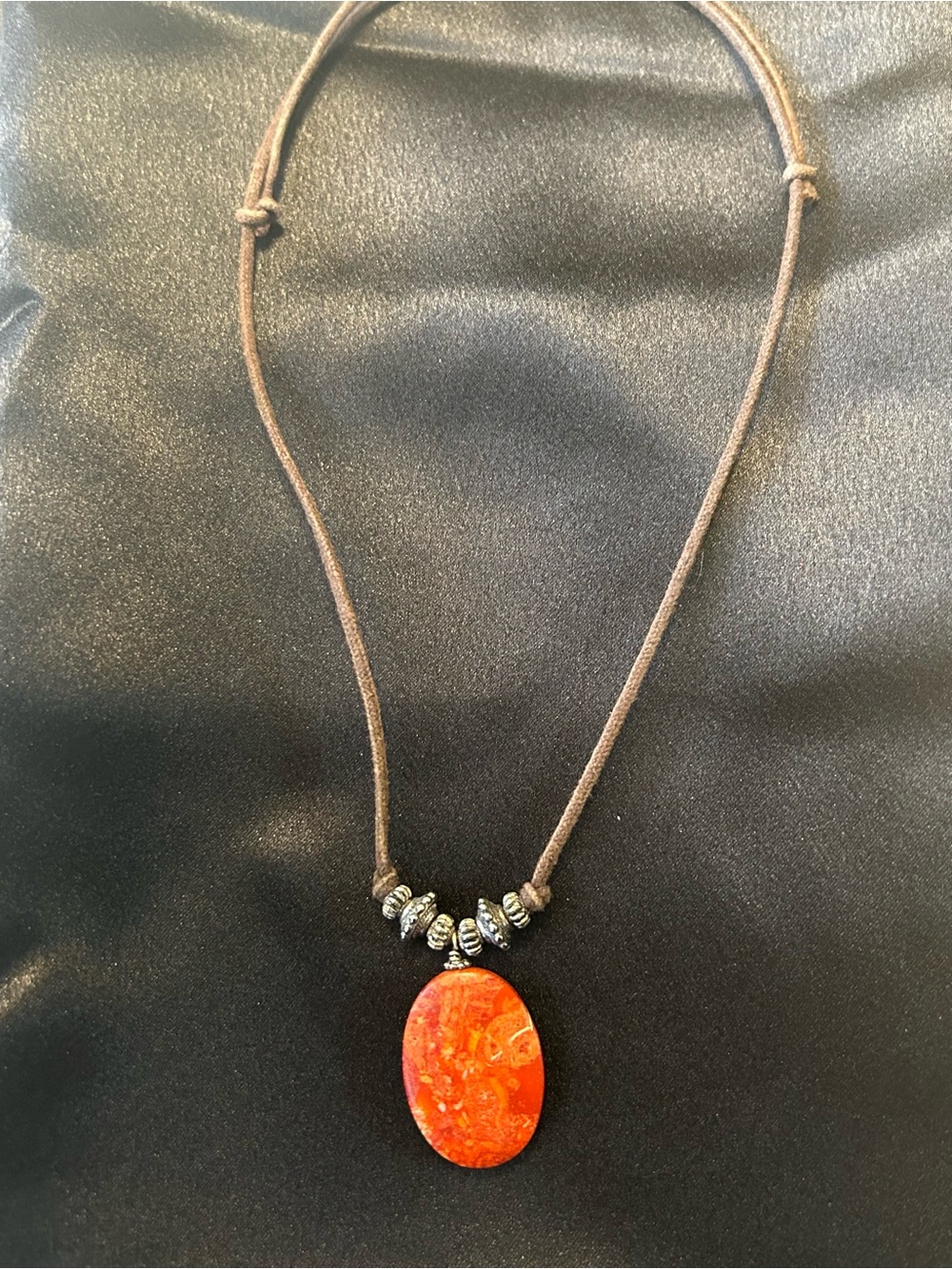 Red agate cabochon pendant on brown cord/silver tone beads